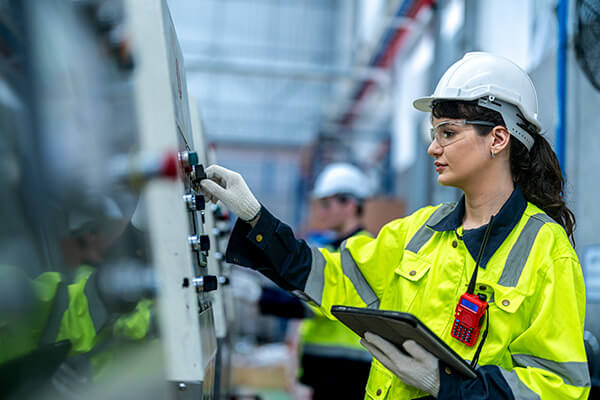 Male and female engineers in a manufacturing facility